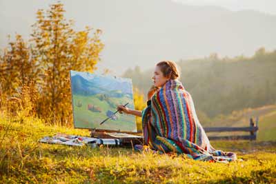 Lady artist painting outside